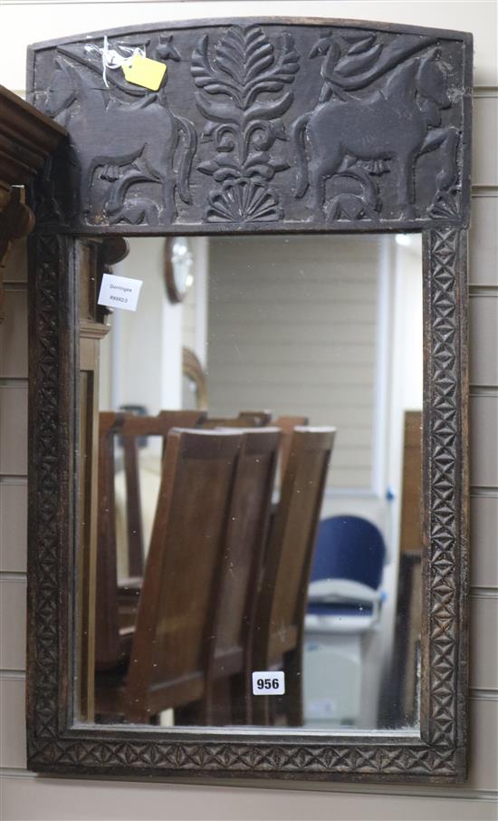 An African carved wood mirror W.45cm